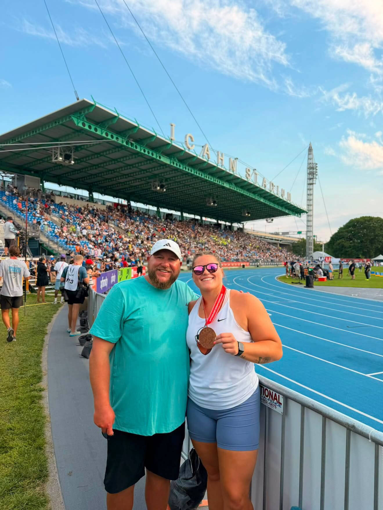 An alum athlete poses with her bronze medal